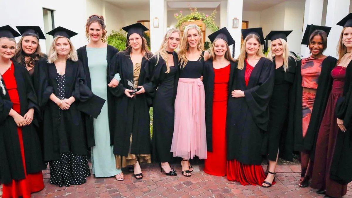 Helderberg School of Beauty graduates in caps and gowns celebrating their accredited qualifications