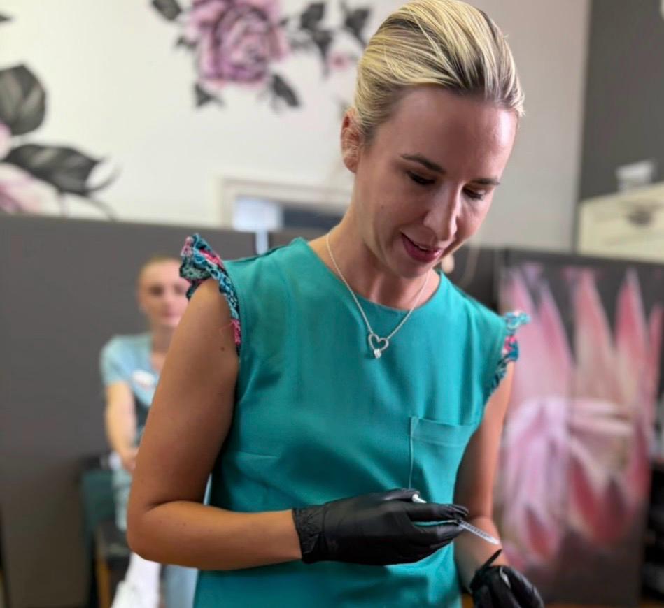 Instructor preparing a treatment with gloves in the beauty school salon