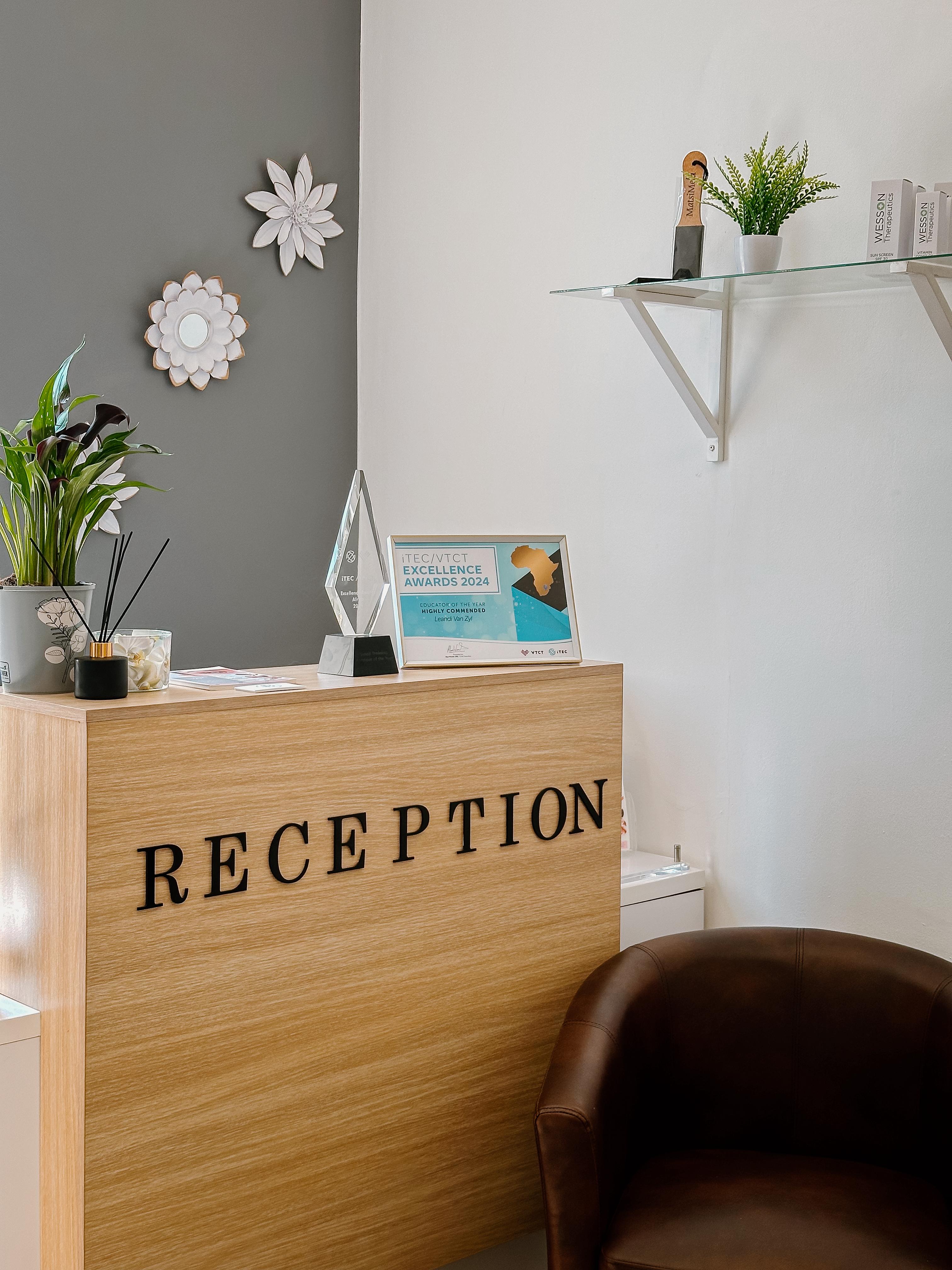 Reception desk with ITEC/VTCT Excellence Awards at Helderberg School of Beauty
