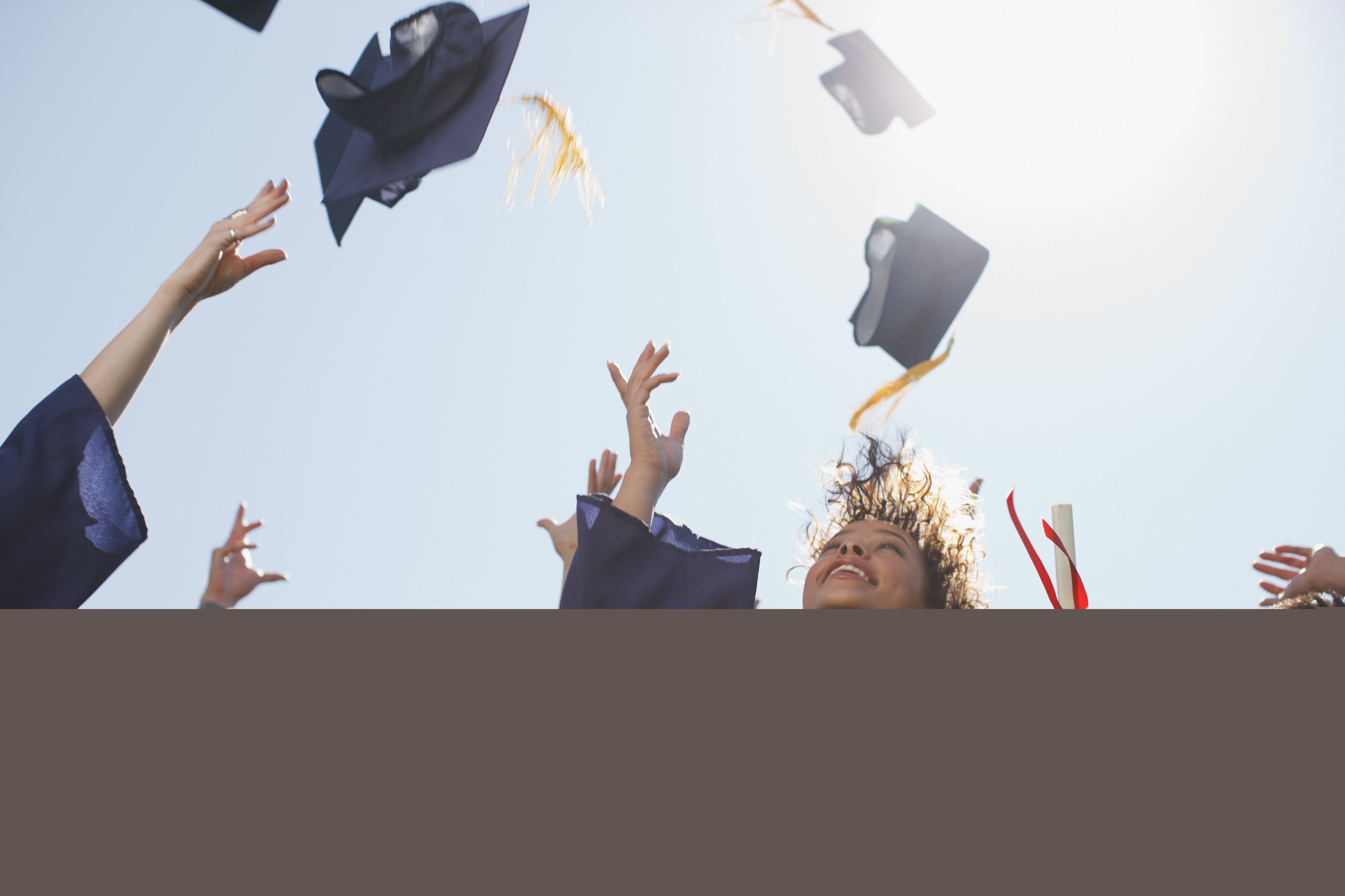 Graduates throwing caps in celebration