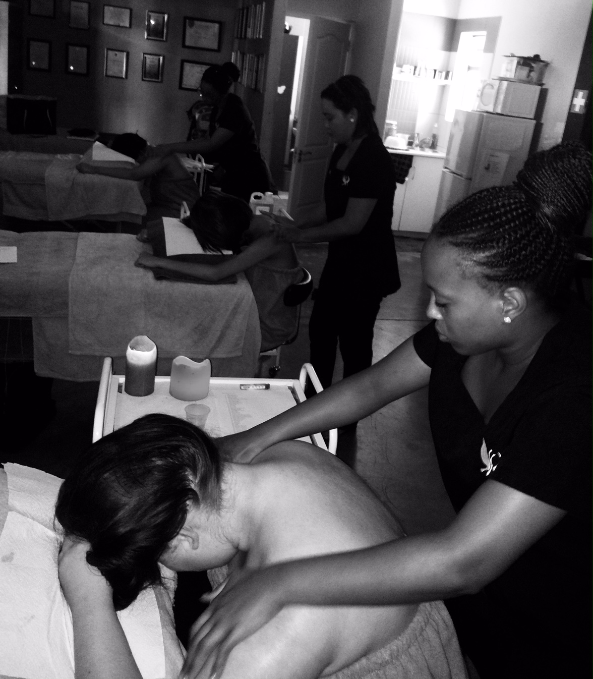 Students performing massages in the salon
