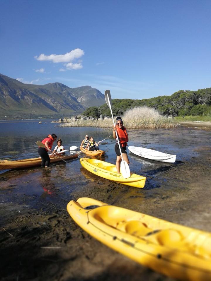 Group of people kayaking on a lake during team building