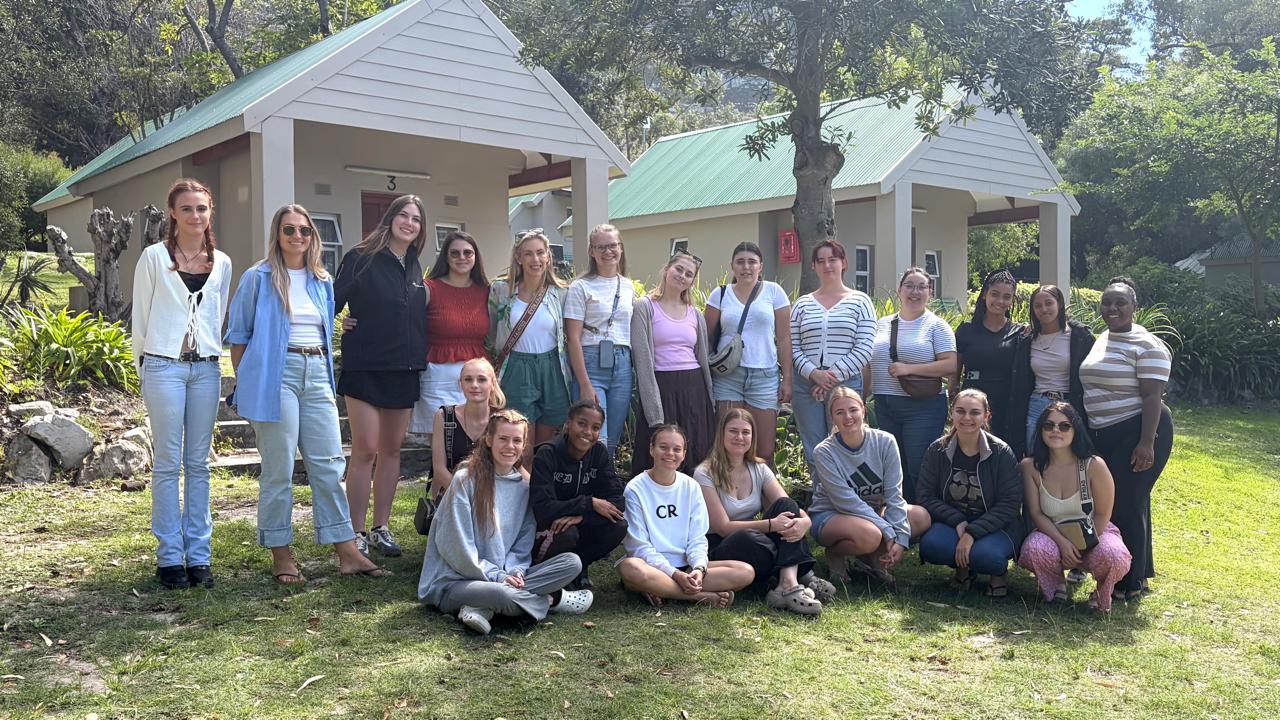 Students gathered outside lodges on a team building getaway